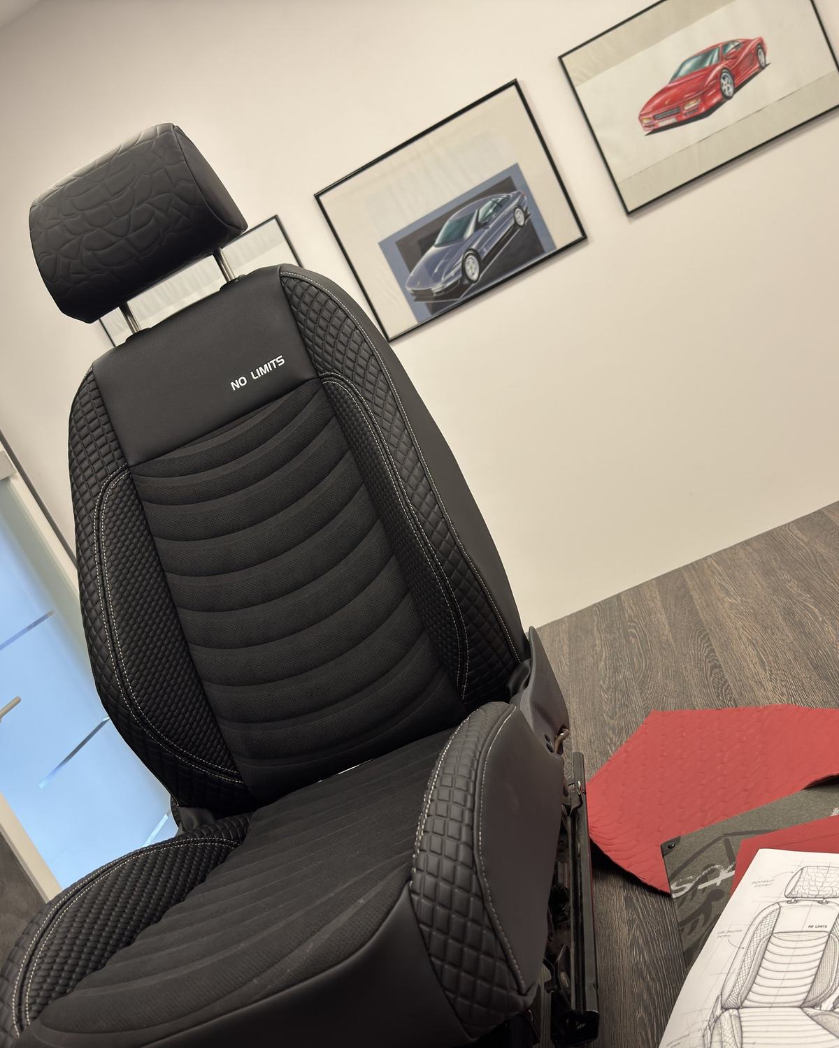 A black seat with quilted stitching and a No Limits inscription, next to its design sketch and red material