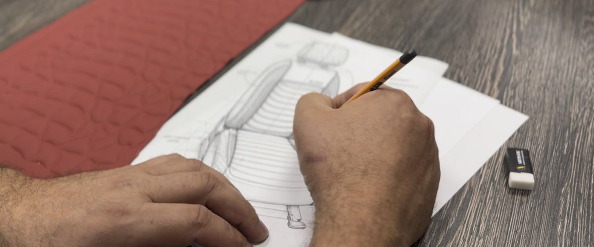 A seat design sketch next to a quilted material sample